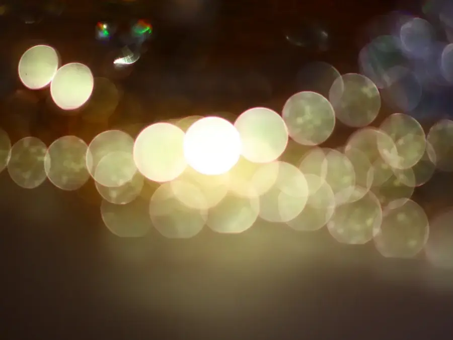 Out-of-focus strand of pearls glowing in warm light