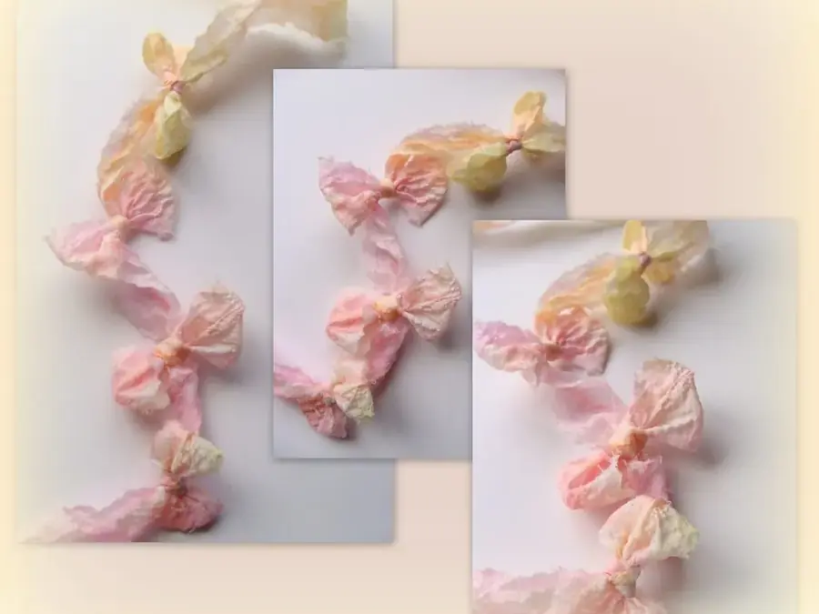 Small pink and cream silk ribbon bows tied along three pale cards