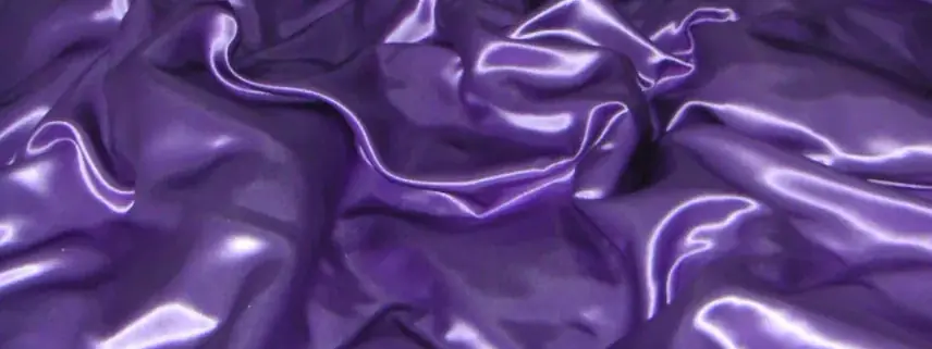 Deep violet satin fabric falling in glossy folds